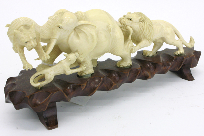 Appraisal: ASIAN IVORY CARVED FIGURAL GROUP lion pride attacking an African