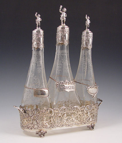 Appraisal: RETICULATED STERLING TANTALUS WITH WHEEL ETCHED DECANTERS Silver mounted etched