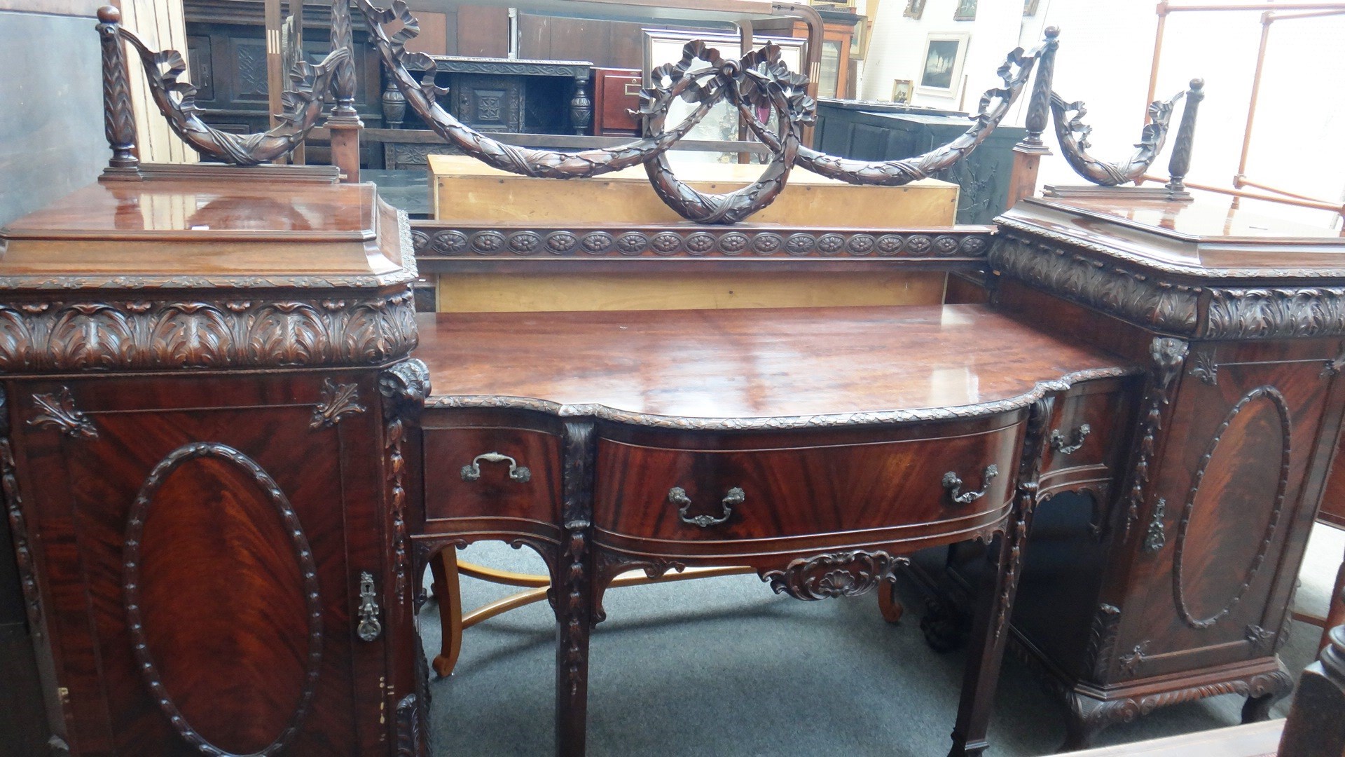 Appraisal: An early th century carved mahogany pedestal sideboard with rams