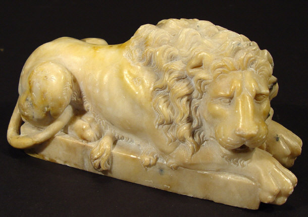 Appraisal: Carved alabaster study of a recumbent lion on a matching