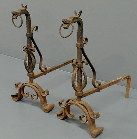 Appraisal: Pair of wrought iron dragon form andirons in the manner