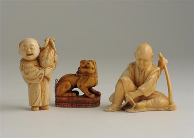 Appraisal: A Japanese ivory carving of a seated figure tying his