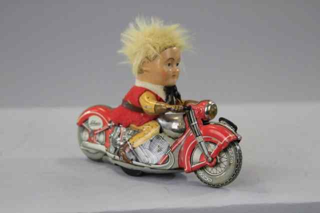 Appraisal: SCHUCO BOY ON MOTORCYCLE Germany lithographed tin Motordrill Clown blonde