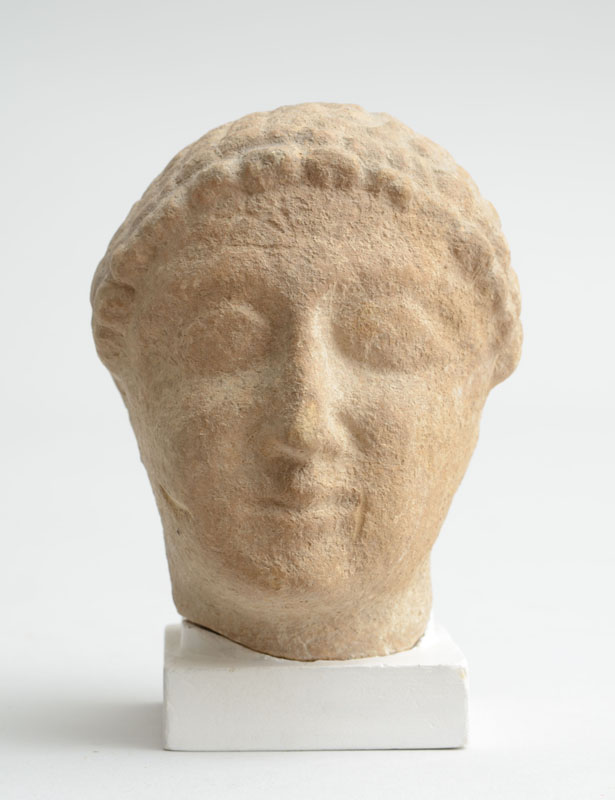 Appraisal: ANCIENT CARVED LIMESTONE HEAD OF A WOMAN On a plaster