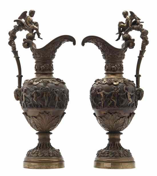 Appraisal: A Pair of Neoclassical Bronze Bacchic Ewers each of baluster