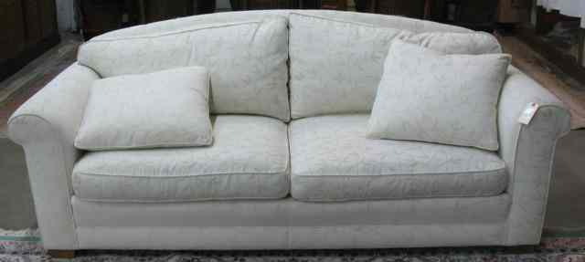 Appraisal: CONTEMPORARY TRADITIONAL STYLE SOFA with ivory on white floral brocade