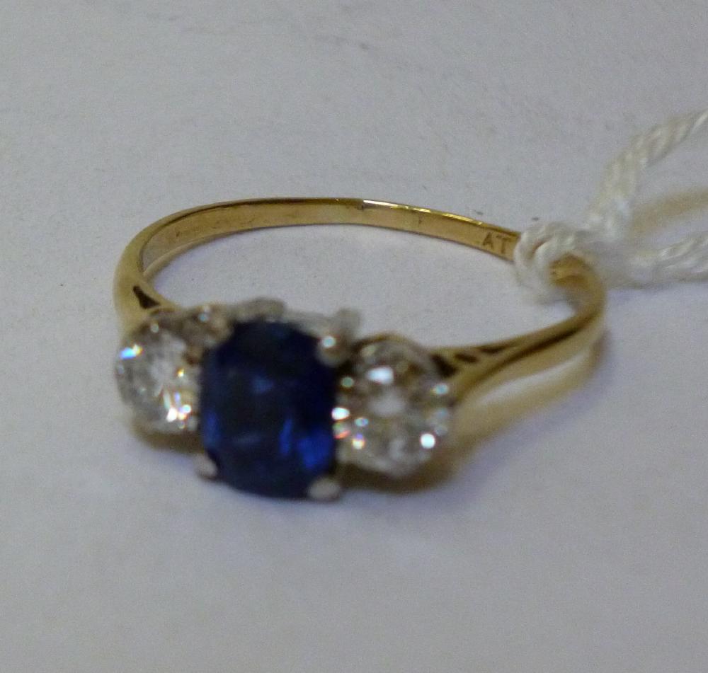 Appraisal: A SAPPHIRE AND DIAMOND THREE STONE RING the central oval