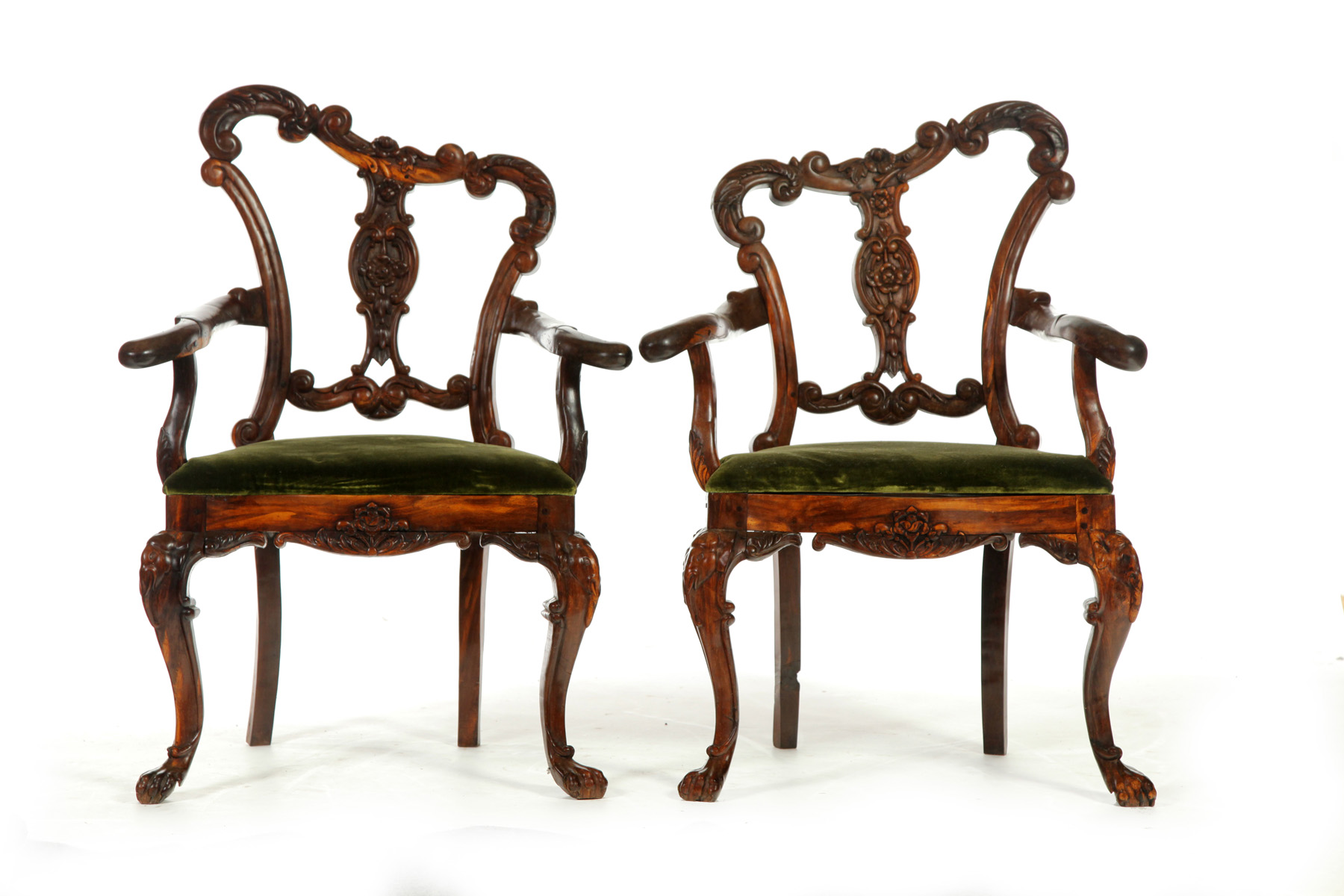 Appraisal: PAIR OF ROCOCO-STYLE ARMCHAIRS Late th century ironwood Elaborately carved