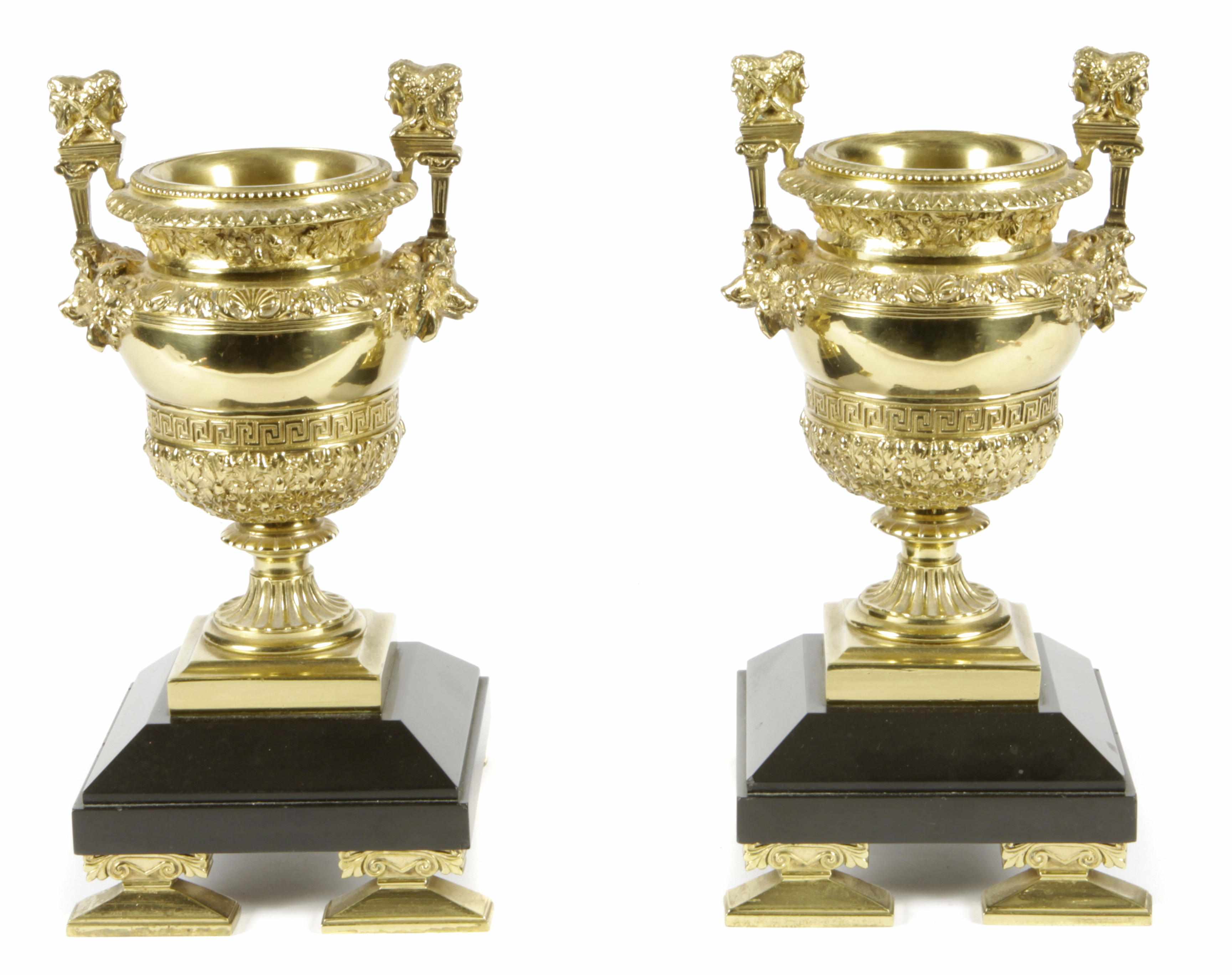 Appraisal: A pair of Neoclassical style brass and black slate urns