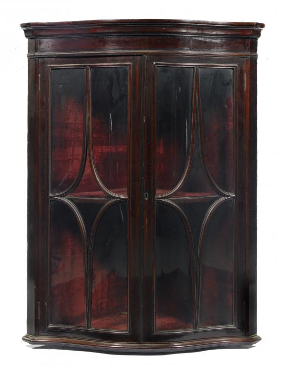 Appraisal: A VICTORIAN MAHOGANY SERPENTINE CORNER CABINET enclosed by a pair