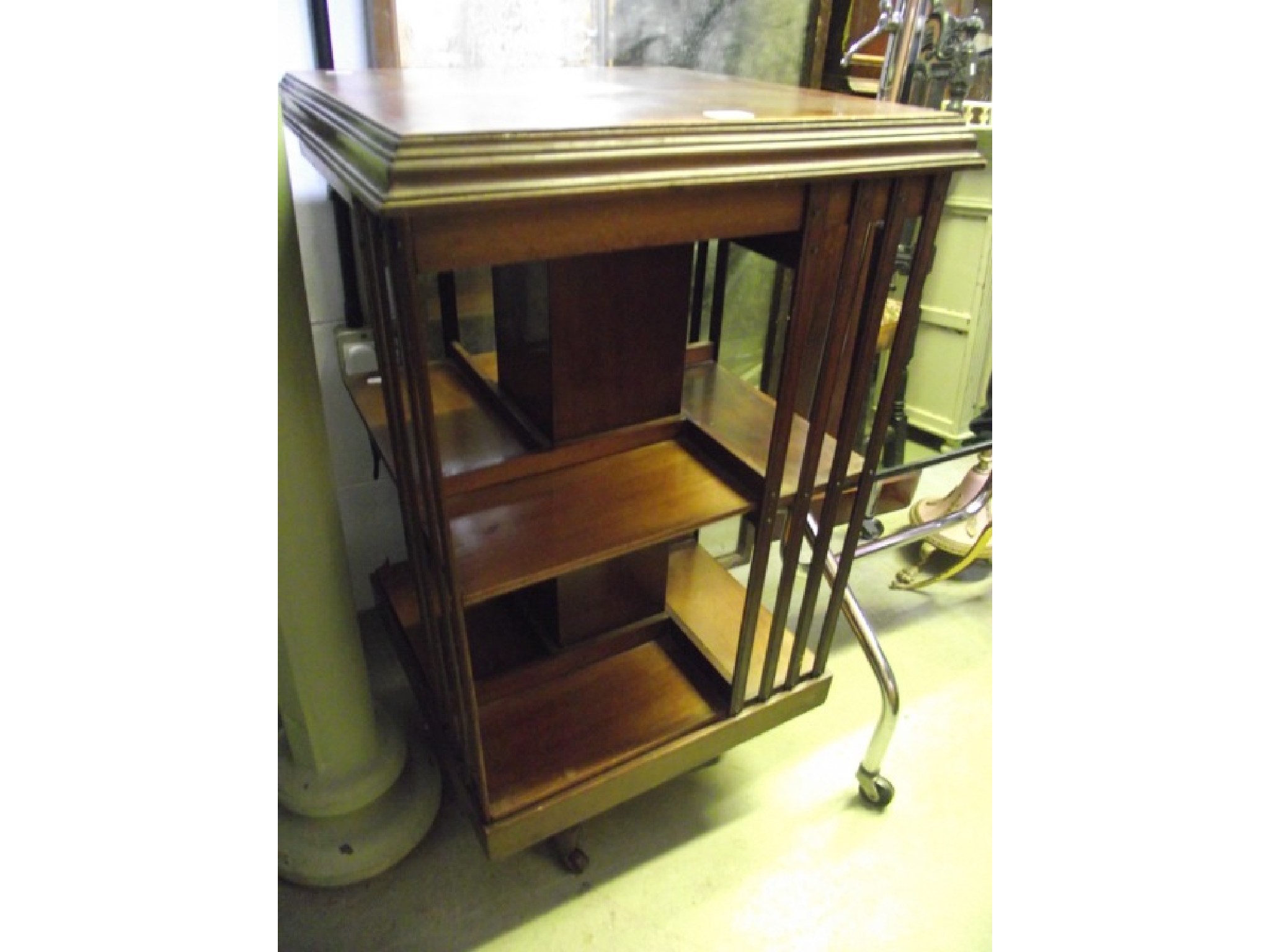 Appraisal: An Edwardian mahogany floorstanding revolving bookcase of square cut form