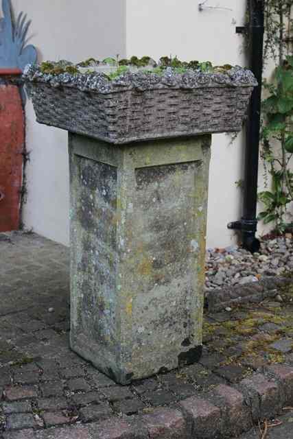 Appraisal: A PANELLED SQUARE SECTION TALL PLINTH surmounted by a Haddonstone