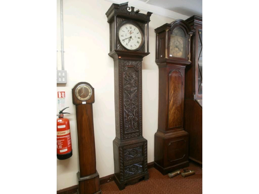 Appraisal: A thC carved oak long cased clock with circular painted