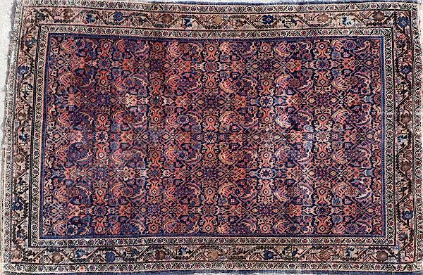 Appraisal: A PERSIAN RUG WITH OVERALL HERATI PATTERN A PERSIAN RUG