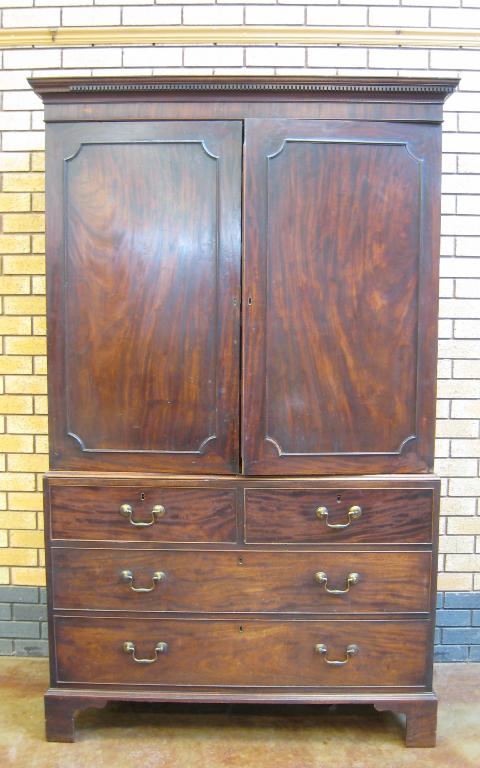 Appraisal: A George III mahogany Linen Press with dentil cornice above