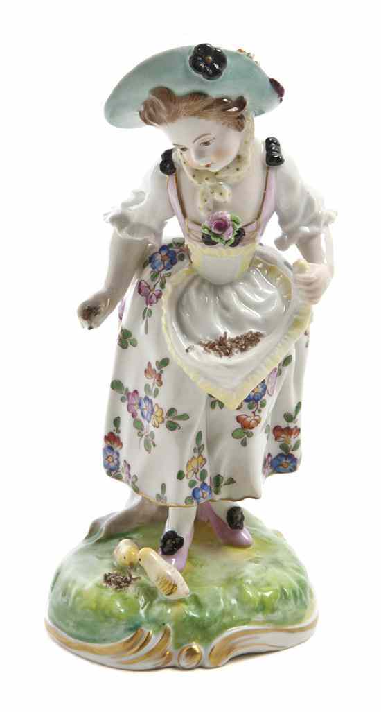 Appraisal: A Continental Porcelain Figure depicting a girl feeding two chicks