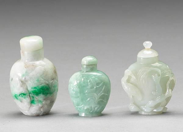 Appraisal: Including two jadeite bottles each carved in low relief with