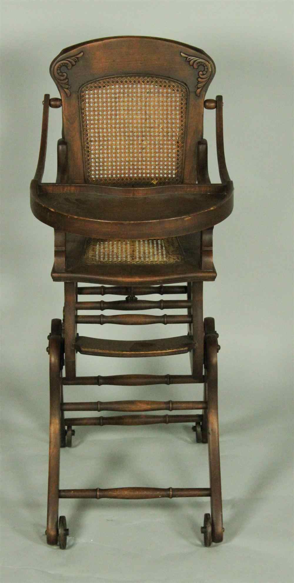 Appraisal: VICTORIAN WALNUT FOLDING ROCKING HIGH CHAIR having an arched crest