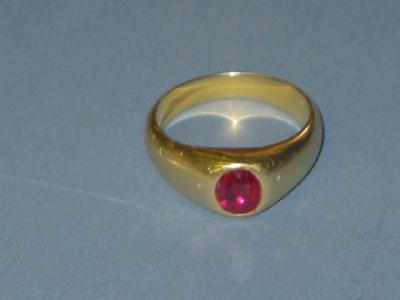 Appraisal: A GENTLEMAN'S RUBY RING the oval cut stone in rub-over