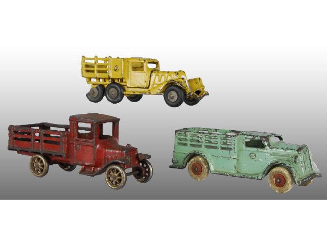 Appraisal: Lot of Cast Iron Stake Truck Toys Description Red Arcade