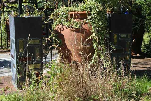 Appraisal: A SET OF FOUR TALL SQUARE SECTION LEAD PLANTERS set