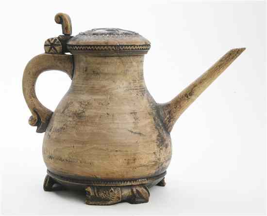 Appraisal: A Continental Carved Wood Teapot the circular lid with a