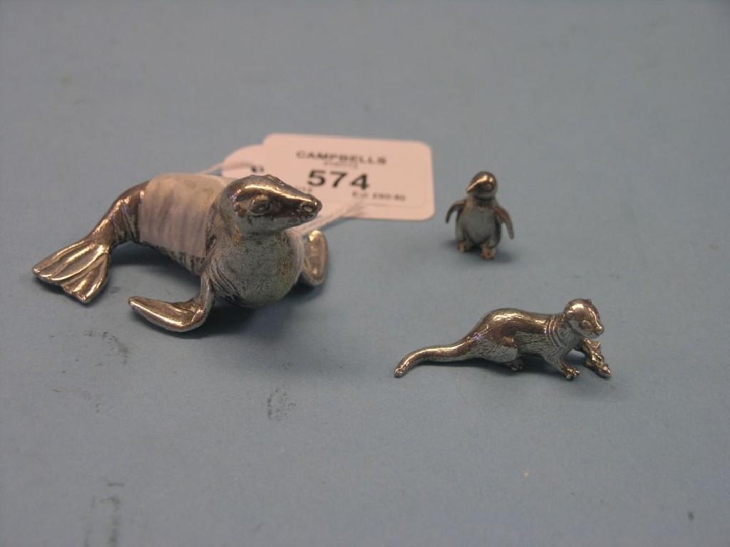 Appraisal: Three small silver animal models a seal otter and penguin