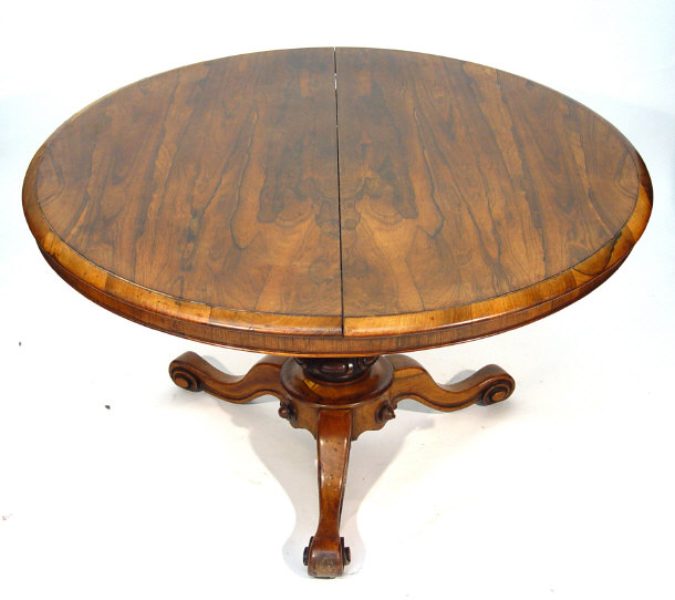 Appraisal: Victorian circular walnut loo table supported by a tapering cylindrical