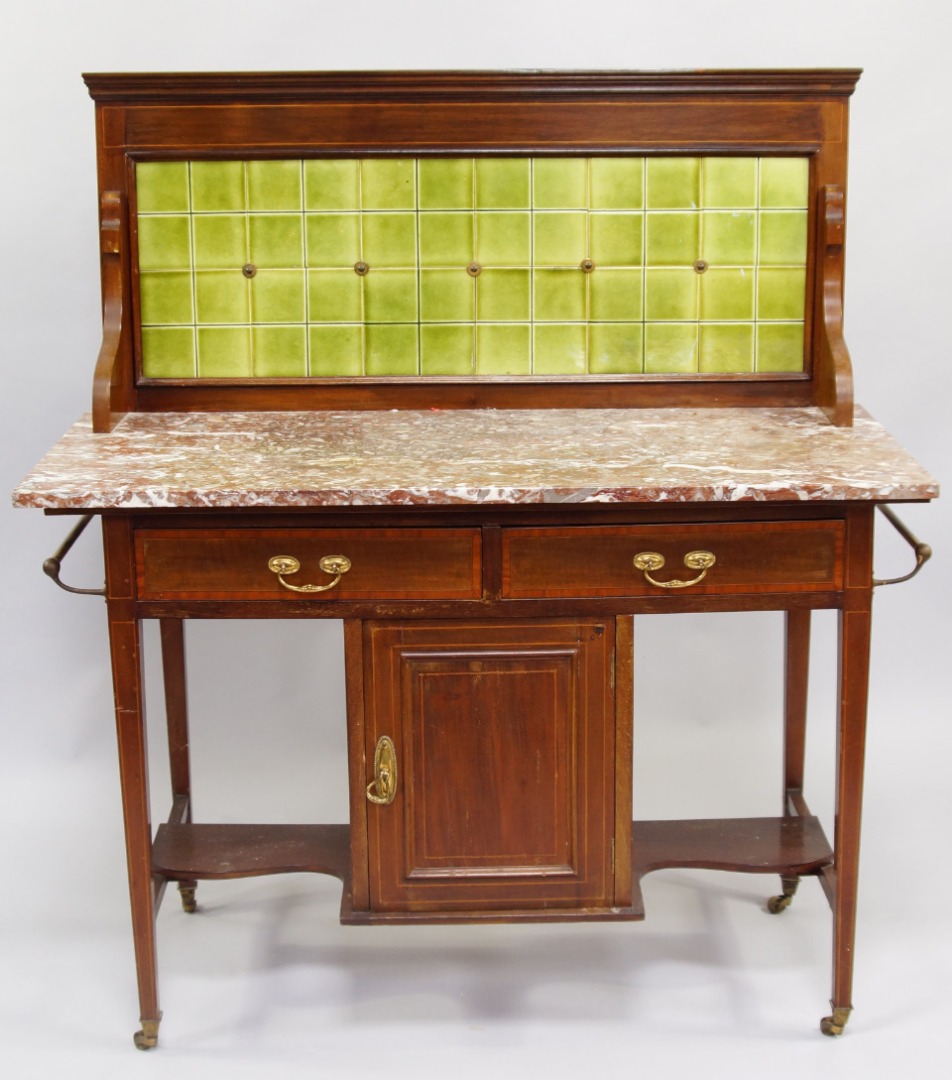 Appraisal: An Edwardian mahogany and red marble topped washstand with green