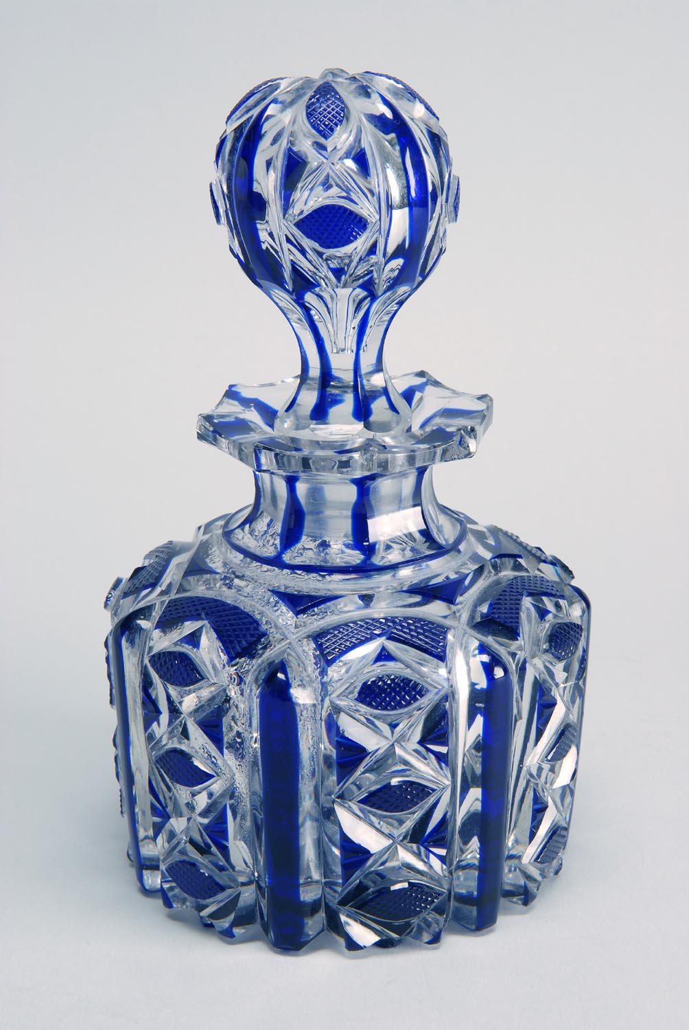 Appraisal: COBALT BLUE-CUT-TO-CLEAR COLOGNE BOTTLE With matching stopper Height ConditionSome roughage