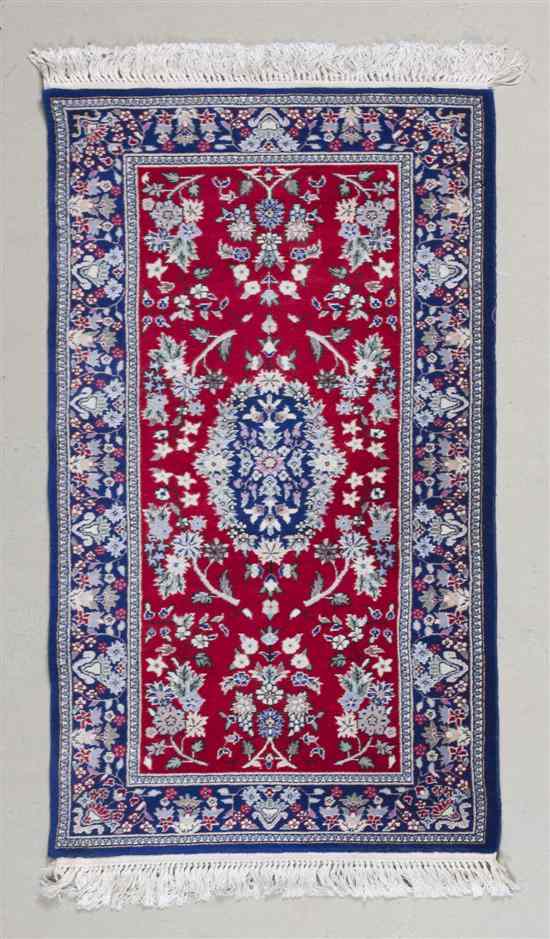 Appraisal: A Persian Wool Rug having stylized floral decoration on a