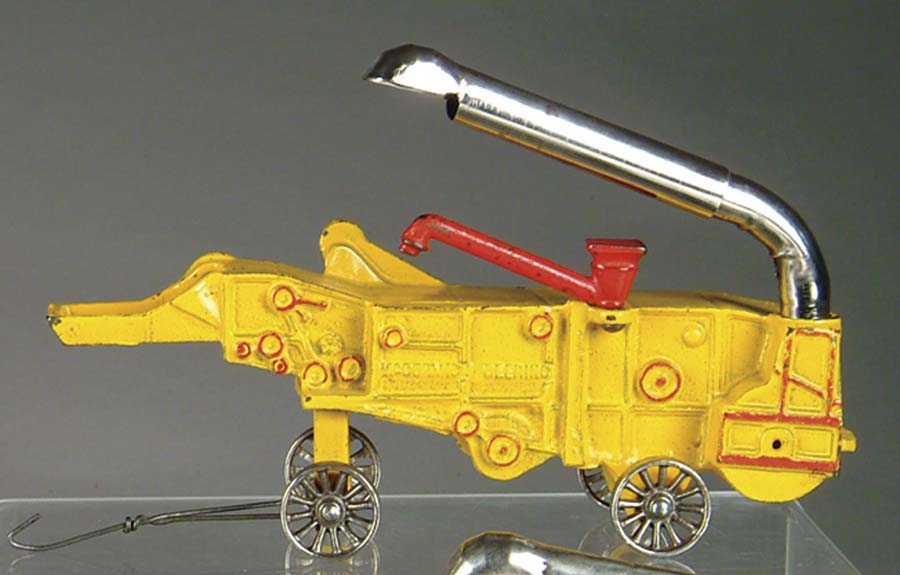 Appraisal: MCCORMICK-DEERING COMBINE BY ARCADE Painted in yellow and embossed MCCORMICK-DEERING