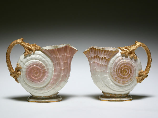 Appraisal: Pair Willets Belleek nautilus pitchers with gilt trim H Good