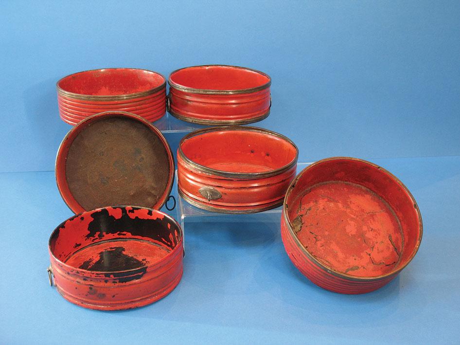 Appraisal: A MATCHED SET OF SIX REGENCY RED LACQUERED BOTTLE COASTERS