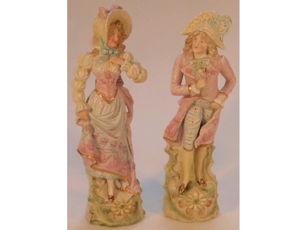 Appraisal: A pair of German bisque figures of a dandy and