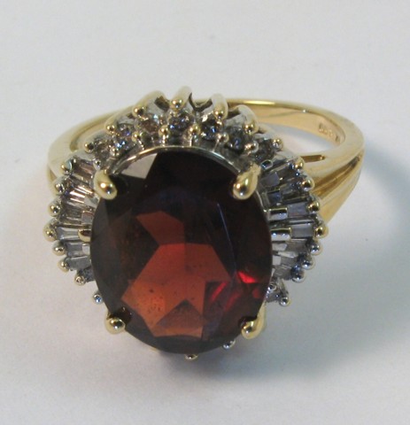 Appraisal: GARNET DIAMOND AND YELLOW GOLD RING k yellow gold and