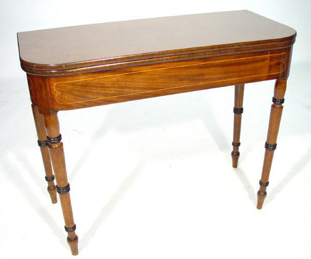 Appraisal: Victorian mahogany foldover tea table with inlaid frieze supported by