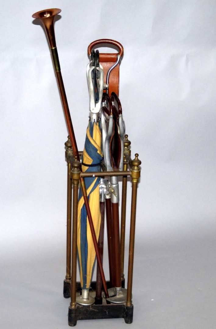 Appraisal: A brass square framed four section stick stand with a