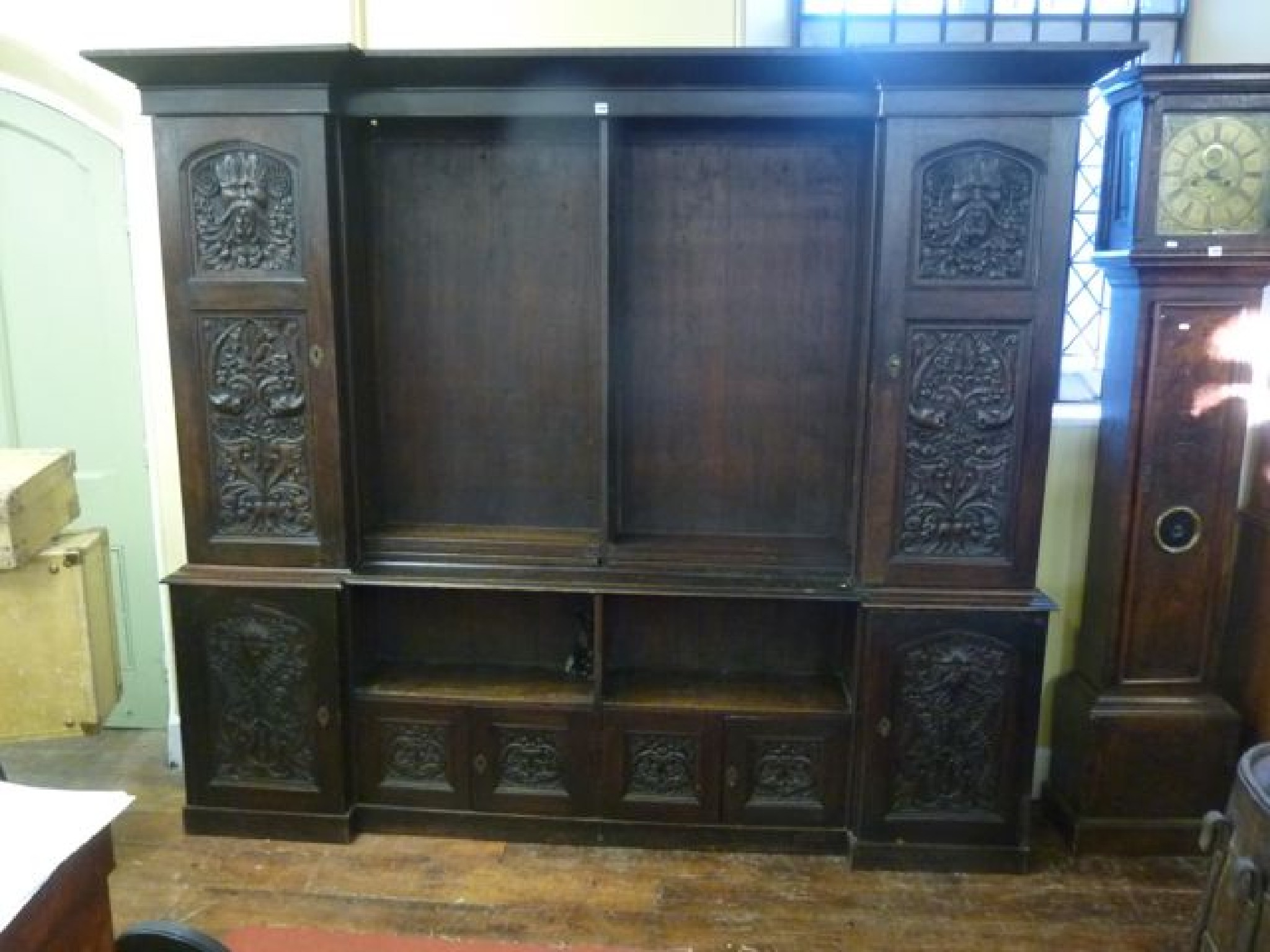 Appraisal: A substantial Victorian oak inverted breakfront bookcase the lower section