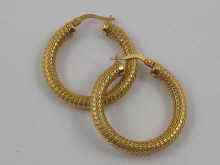 Appraisal: A pair of textured yellow metal tests ct gold hoop