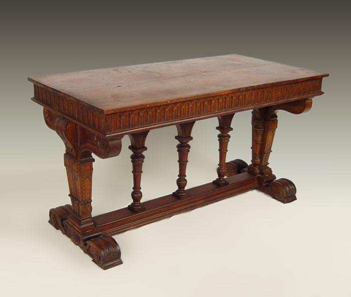 Appraisal: CARVED GOTHIC STYLE TRESTLE BASE LIBRARY TABLE Maple and walnut