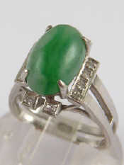 Appraisal: A white metal tests carat gold jade and diamond ring