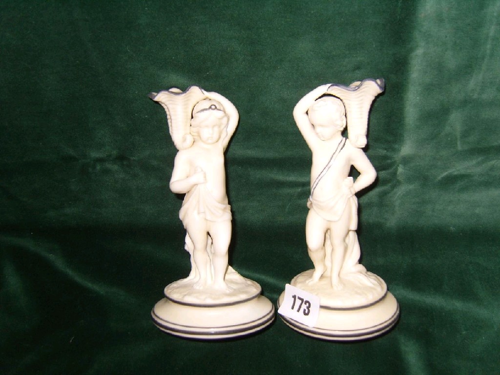 Appraisal: A pair of Victorian Royal Worcester ivory coloured candlesticks in