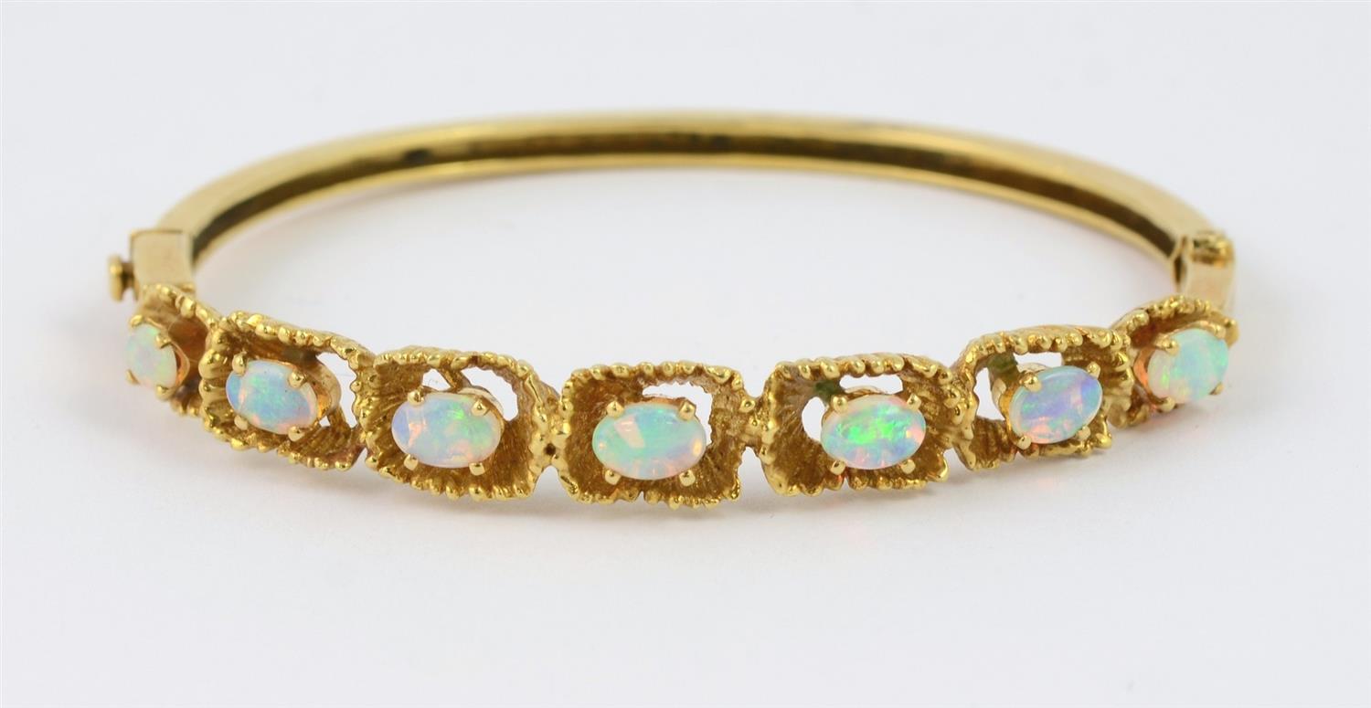 Appraisal: K Yellow gold hinged bangle bracelet set with oval opals