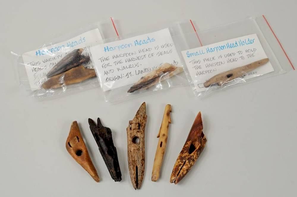 Appraisal: Nine Inuit Carved Fossilized Hunting Items Nine Inuit carved fossilized