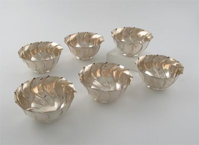 Appraisal: A set of six Edwardian wrythen fluted bowls with shaped