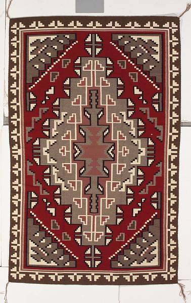 Appraisal: A Navajo rug Finely woven with a complex central diamond-form