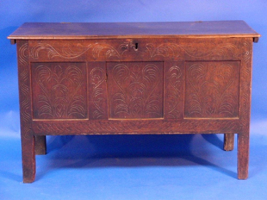 Appraisal: An early thC oak coffer with plain moulded top carved