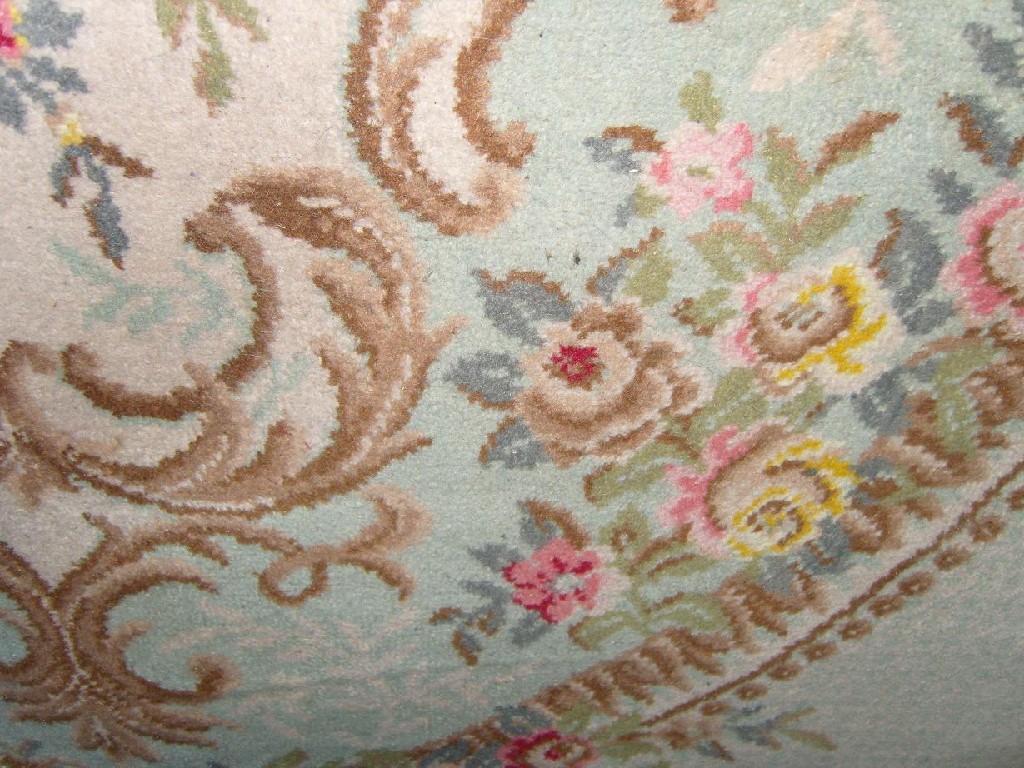 Appraisal: A cream and pale green ground wool carpet with floral