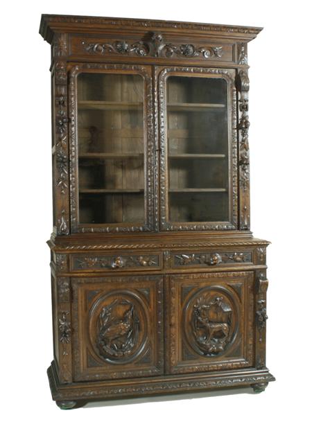 Appraisal: A th century elaborate carved oak bookcase the projected cornice